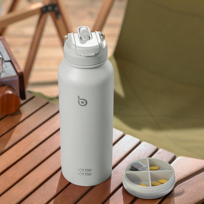 Isolierte Wasserflasche mit Strohhalm und Pillendose, 1,2